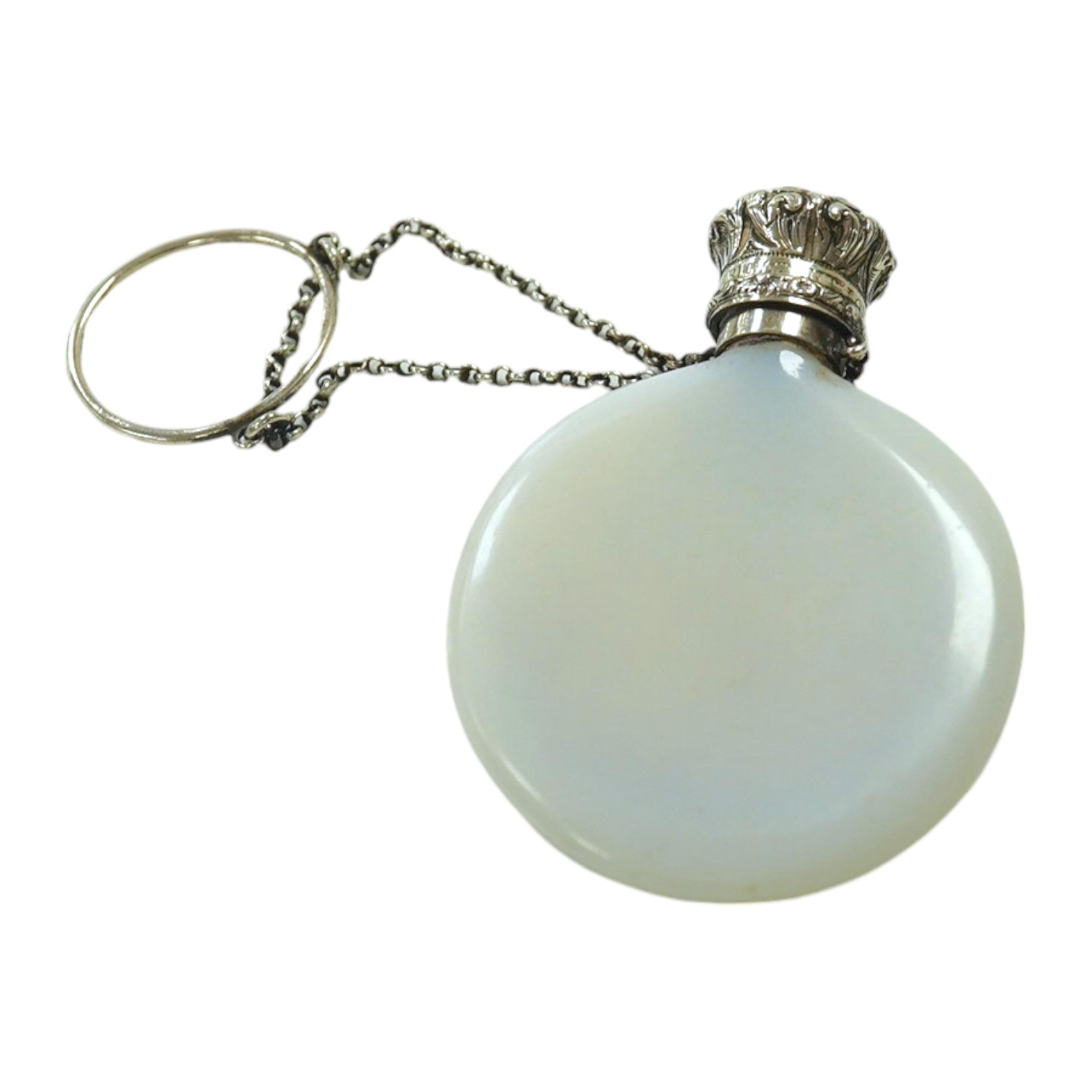 A late Victorian white metal mounted opaline glass R & B Cooper patent moon shaped scent bottle, 57mm, with suspension chain. Condition - fair